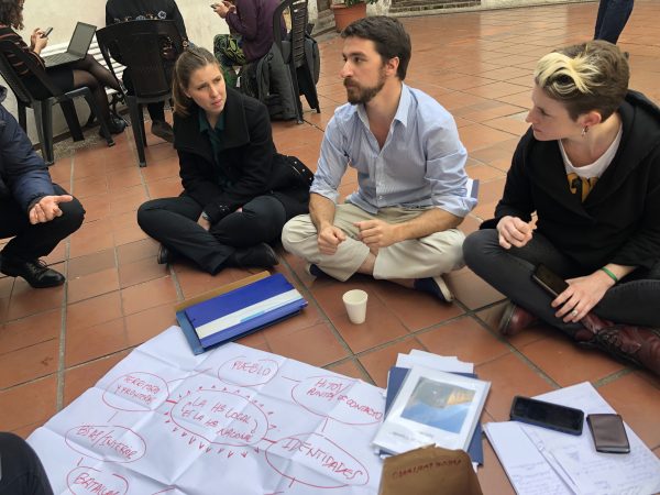 people sitting on the floor with planning charts in front of them