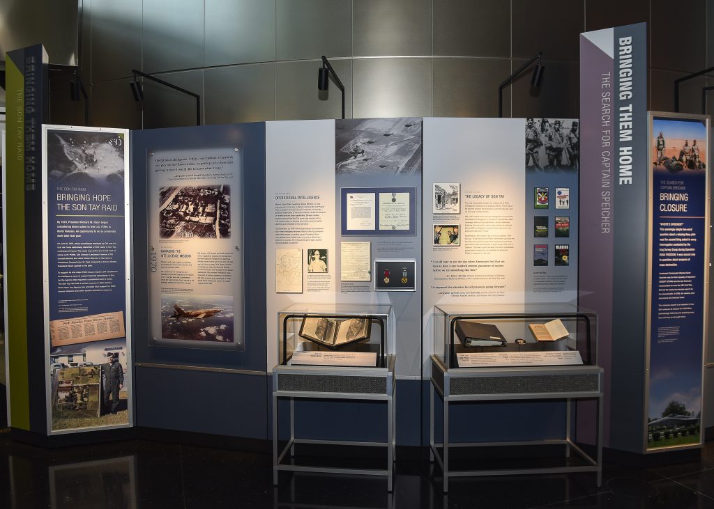 museum display with two cases and several panels