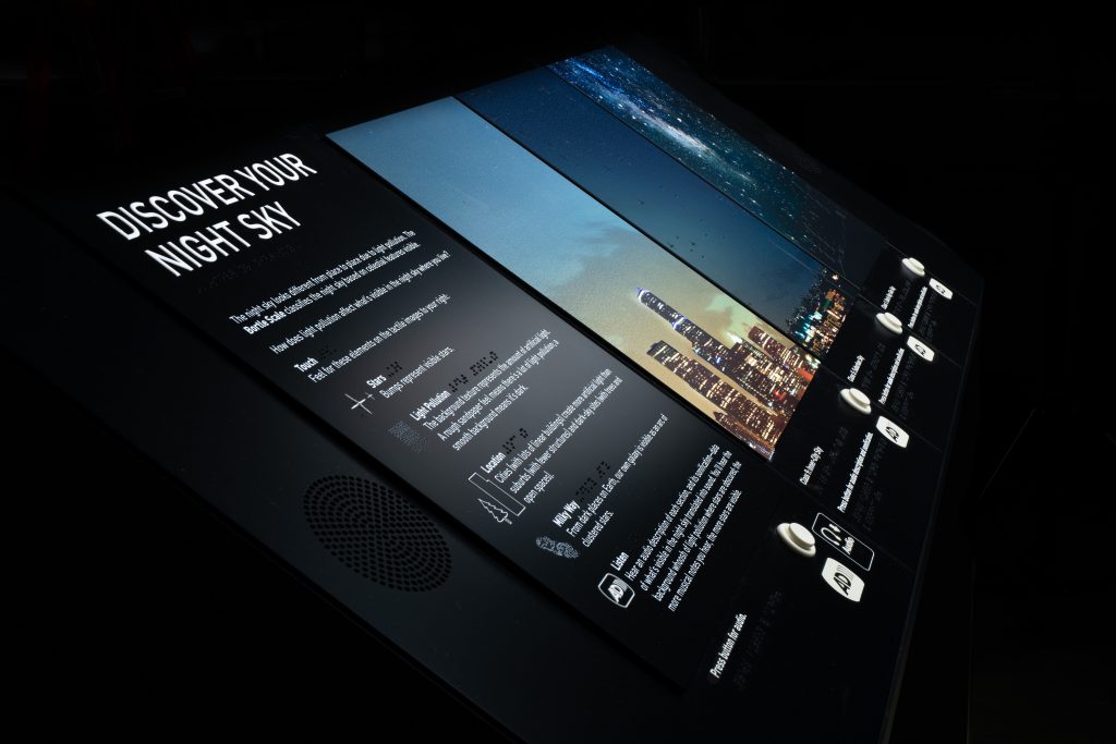 An accessible reader rail prototype with tactile and audio elements.