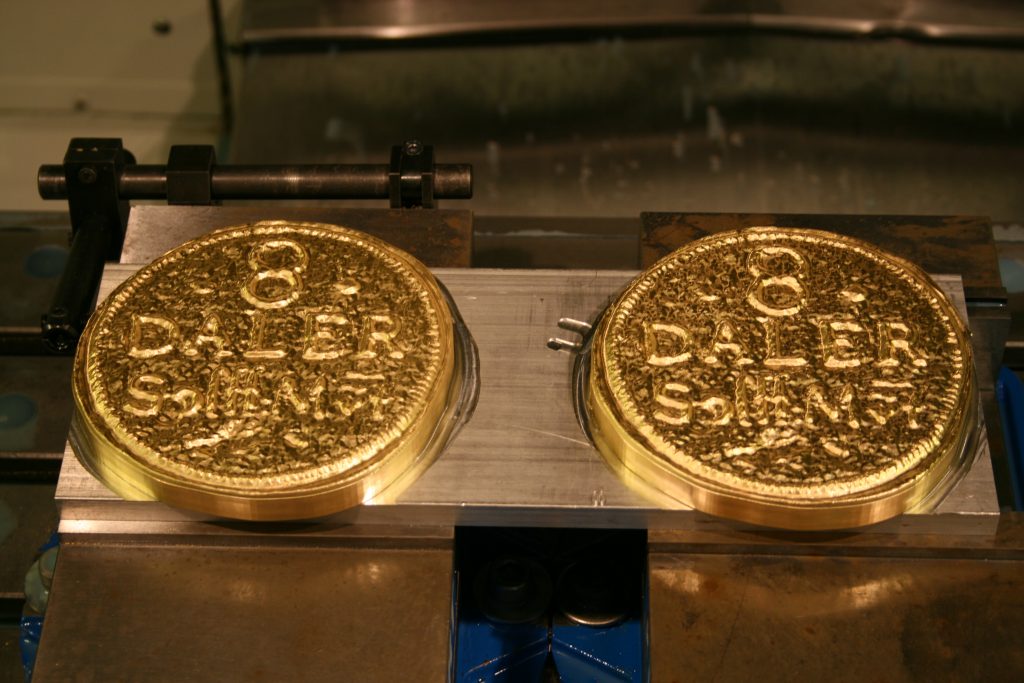 Brass replicas of the 8-daler stamps before the patina was applied