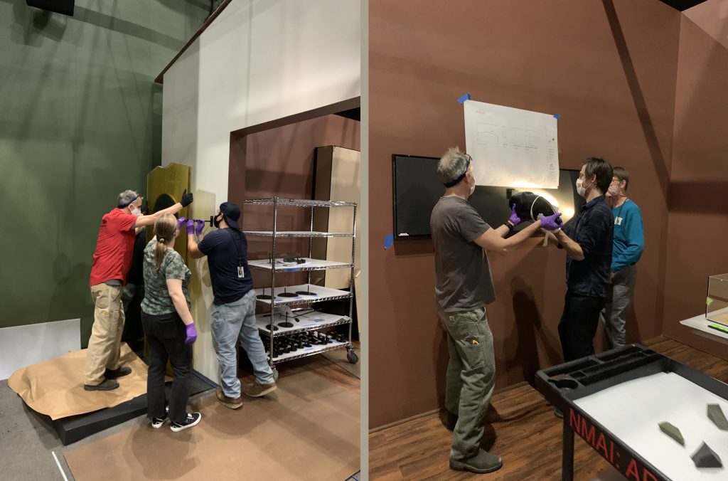 SIE staff assist with installing the exhibition.