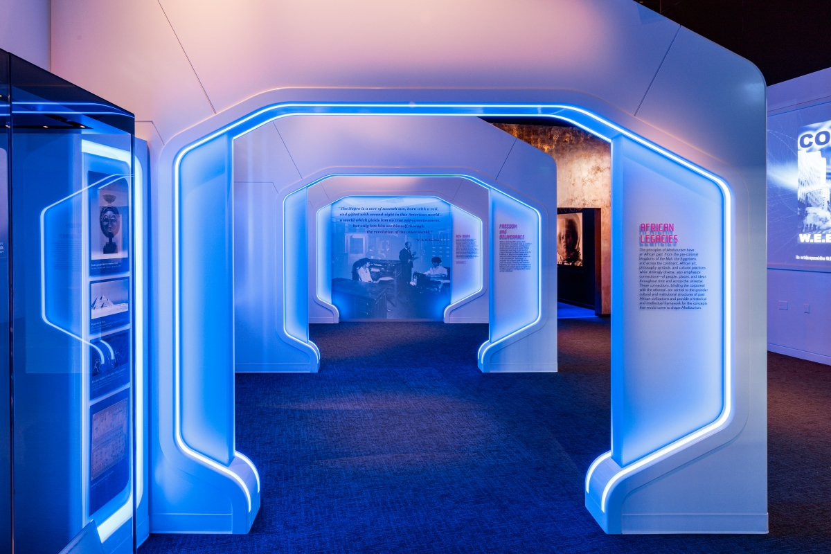 A series of three glowing blue arches leading toward a graphic panel with text and an image.