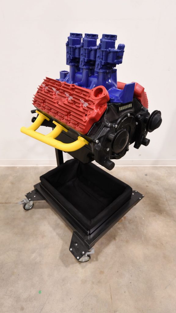 Red, blue, yellow, and black engine model